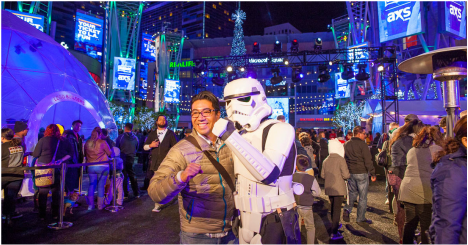 A man poses for a photo with a Star Wars storm trooper at an event on Xbox Plaza.