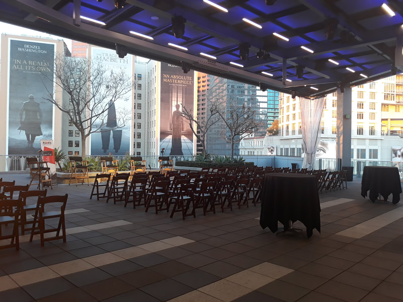 A panel setup with stage and chairs at The Rooftop Terrace.